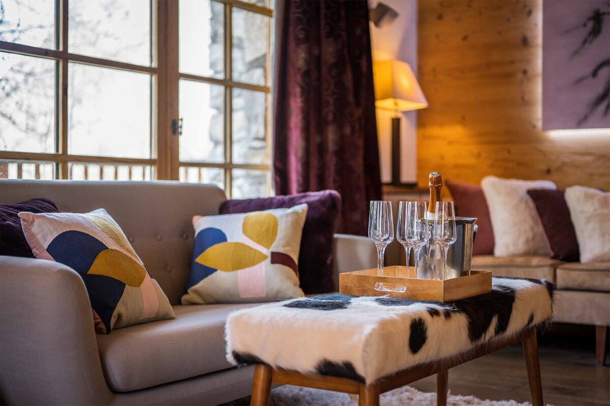 A living room with a couch and a table with glasses on it