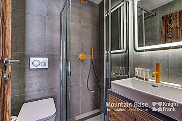 A bathroom with a knight frank logo on the wall
