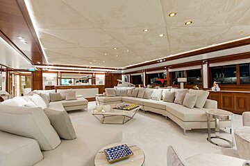 A living room with white furniture and a piano