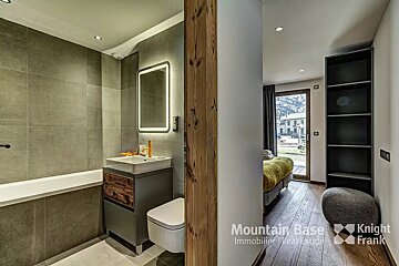 A bathroom with the words mountain base knight frank on the wall
