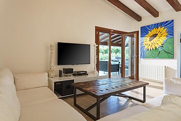 A living room with a painting of a sunflower on the wall
