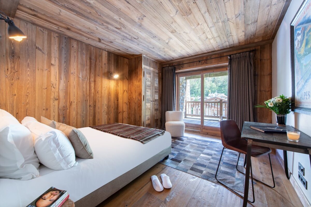A bedroom with a sliding glass door and a poster on the wall that says ' altitude '
