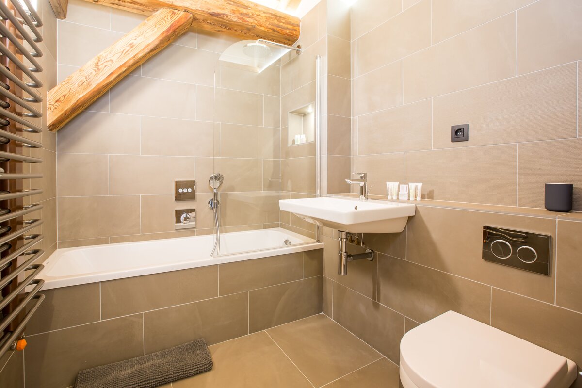 A bathroom with a bathtub sink and toilet