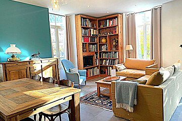 A living room with a white couch and a blue chair
