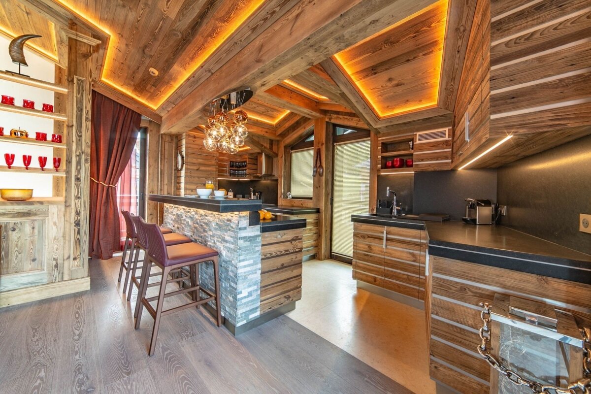 A kitchen with wooden cabinets and a bar