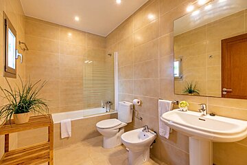 A bathroom with a sink toilet and bathtub