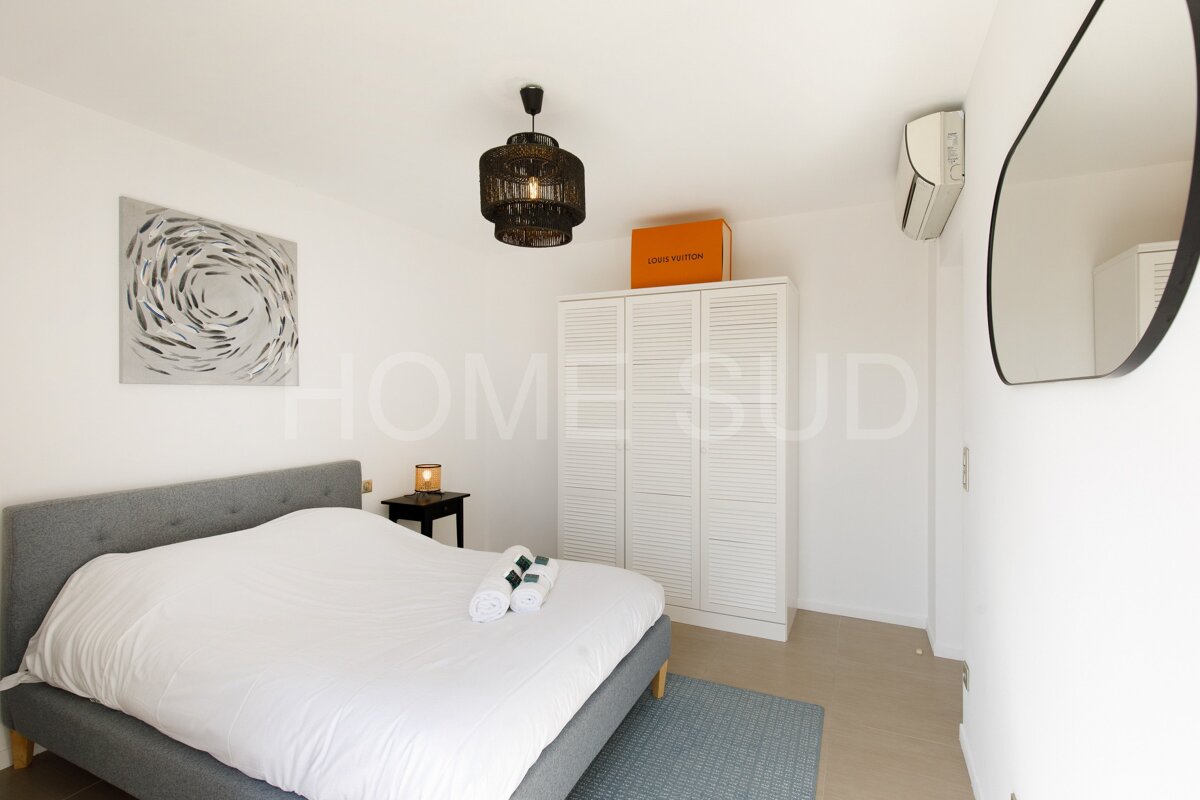 A bedroom with a louis vuitton bag on top of a closet