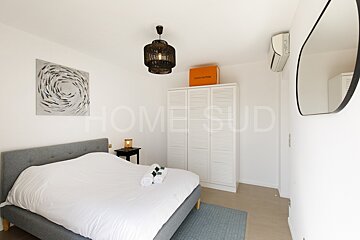 A bedroom with a louis vuitton bag on top of a closet