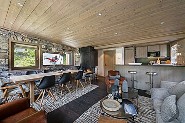 A living room with a dining table and chairs