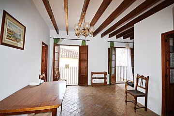 A room with a table and chairs and a picture on the wall