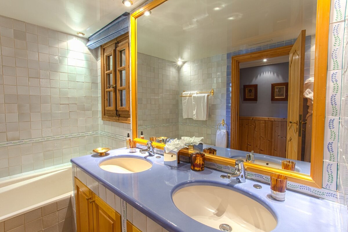 A bathroom with two sinks and a large mirror