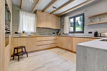 A kitchen with wooden cabinets and a window