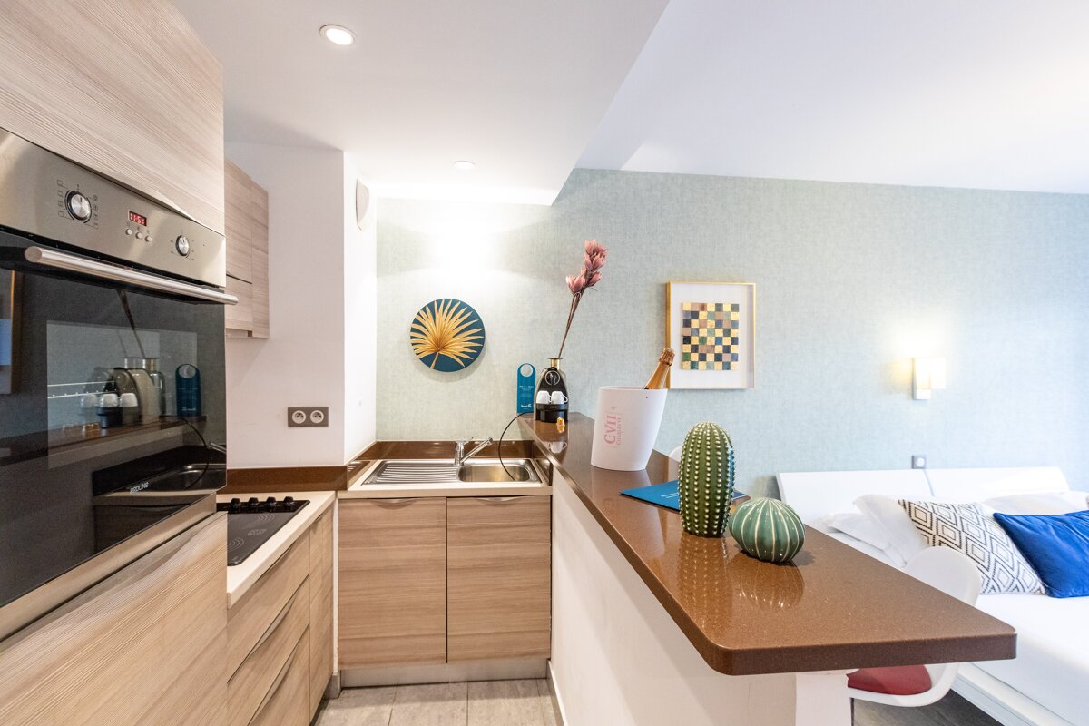 A kitchen with a cactus and a vase that says ' cactus ' on it