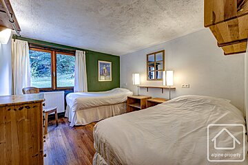 A bedroom with two beds and a sign that says alpine property