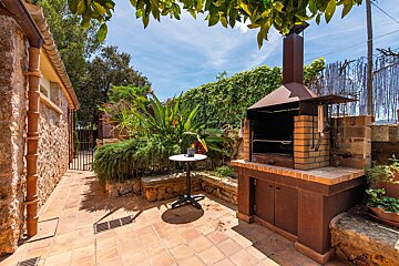 A small table sits in front of a brick grill