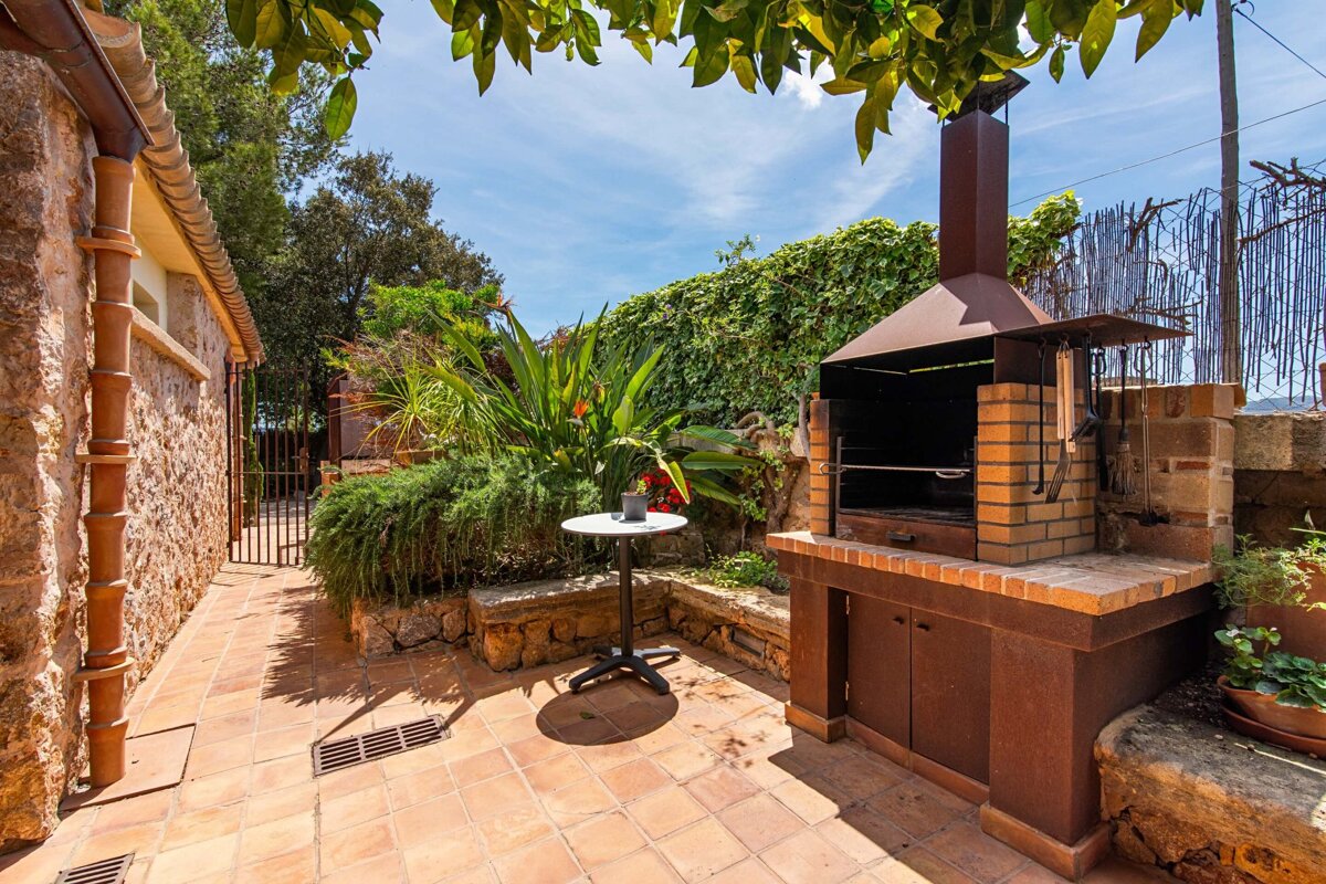 A small table sits in front of a brick grill