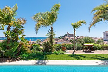 A swimming pool with a view of a city and the ocean