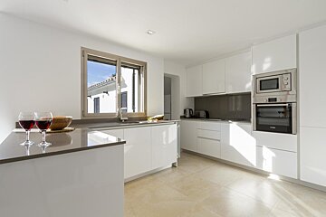 A kitchen with white cabinets and a bosch oven