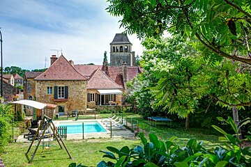 A house with a swimming pool in front of it