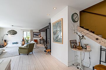 A living room with a clock and a picture on the wall