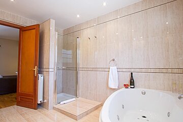 A bathroom with a jacuzzi tub and a bottle of champagne