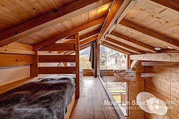A bedroom with bunk beds and a sign that says mountain base knight frank