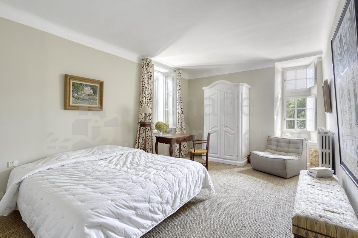 A bedroom with a bed a desk and a chair