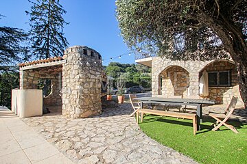 A stone building with a table and chairs in front of it