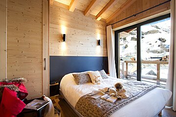 A bedroom with a bed and a large window