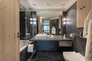 A bathroom with a sink toilet and bathtub