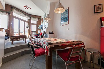 A dining room table with a coca cola table cloth
