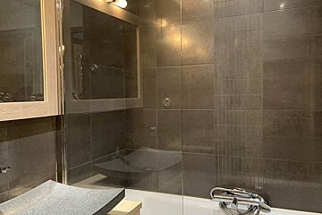 A bathroom with a bathtub and a sink