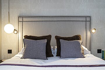 A bed with a headboard and pillows on it