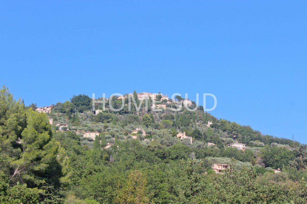 The word home is on a hill with trees