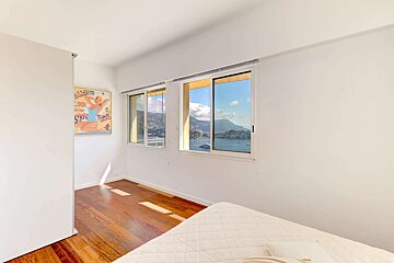 A bedroom with a painting on the wall that says 