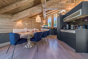 A kitchen and dining area in a log cabin