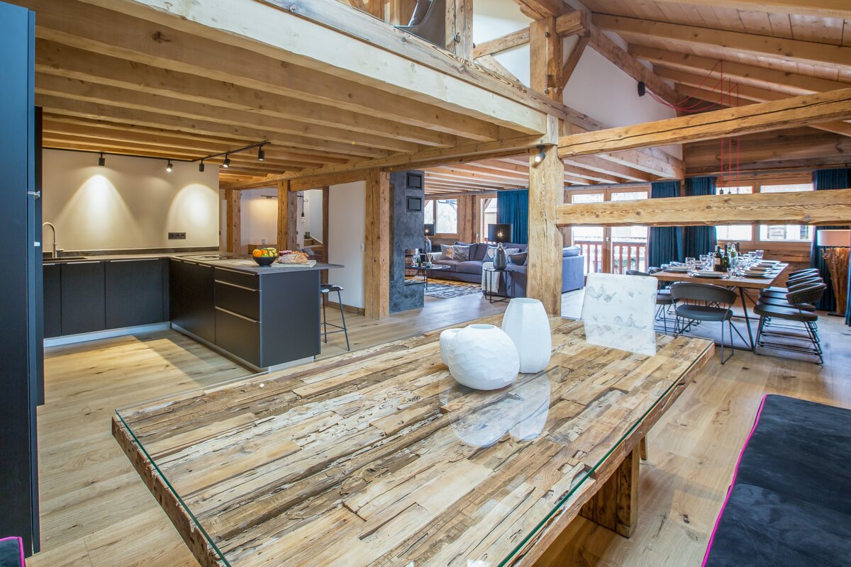 A wooden table with a glass top in a kitchen