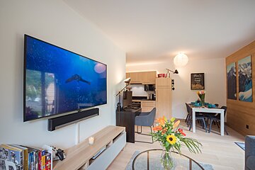 A living room with a sign on the wall that says