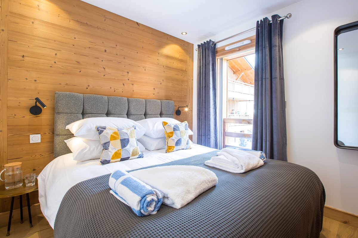 A bedroom with a large bed and a window