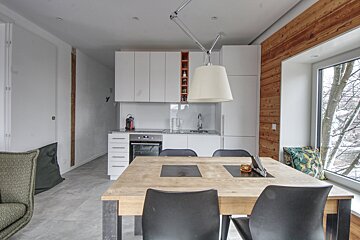 A kitchen with a table and chairs in front of a window