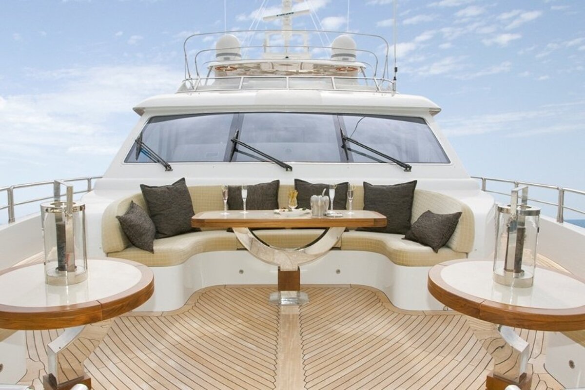 The front of a yacht with a table and two tables