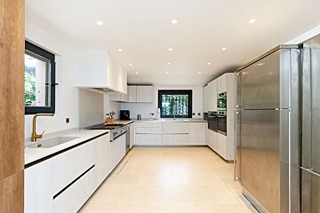 A kitchen with white cabinets and stainless steel appliances