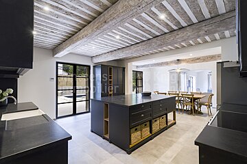A kitchen with a large island and a sign that says immobilier