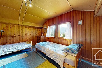 A bedroom with two beds and a sign that says alpine-pro