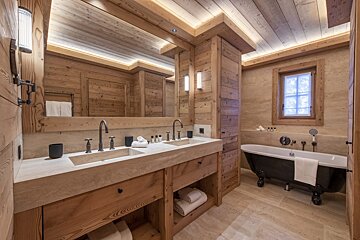A bathroom with two sinks and a bathtub