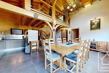 A kitchen and dining room with a picture of a deer on the wall