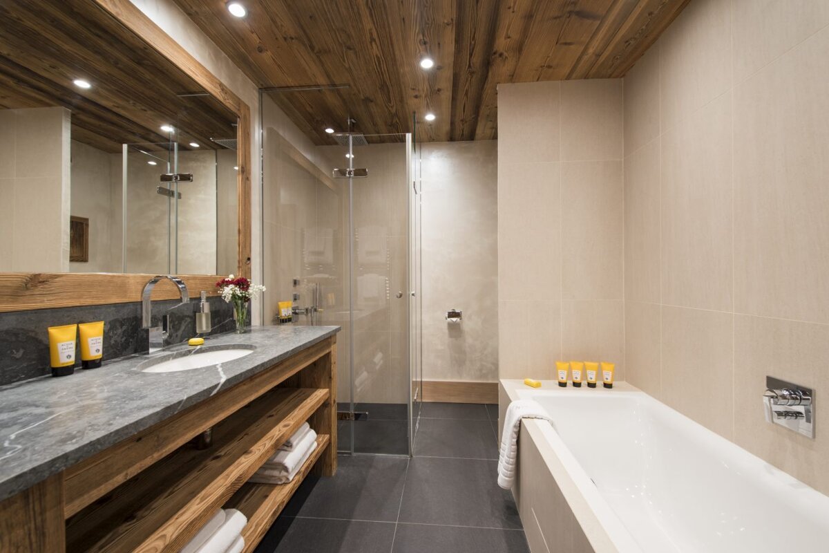 A bathroom with a bathtub a sink and a mirror