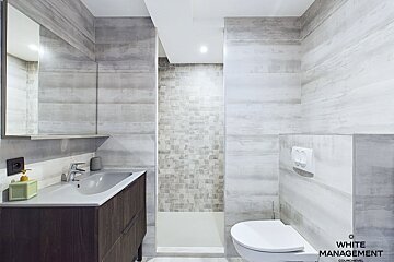 A bathroom with white management written on the wall