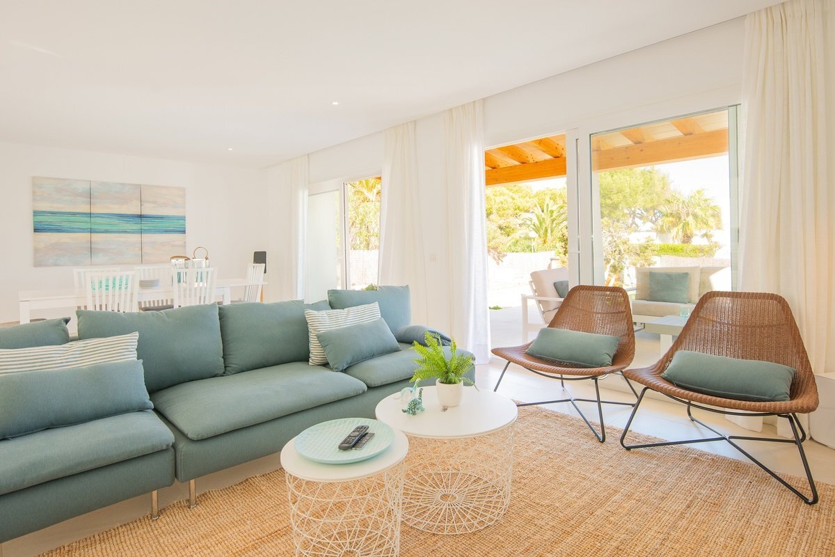 A living room with a blue couch and two chairs