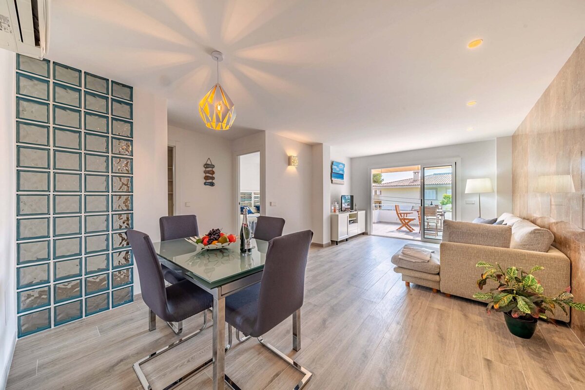 A living room with a dining table and chairs